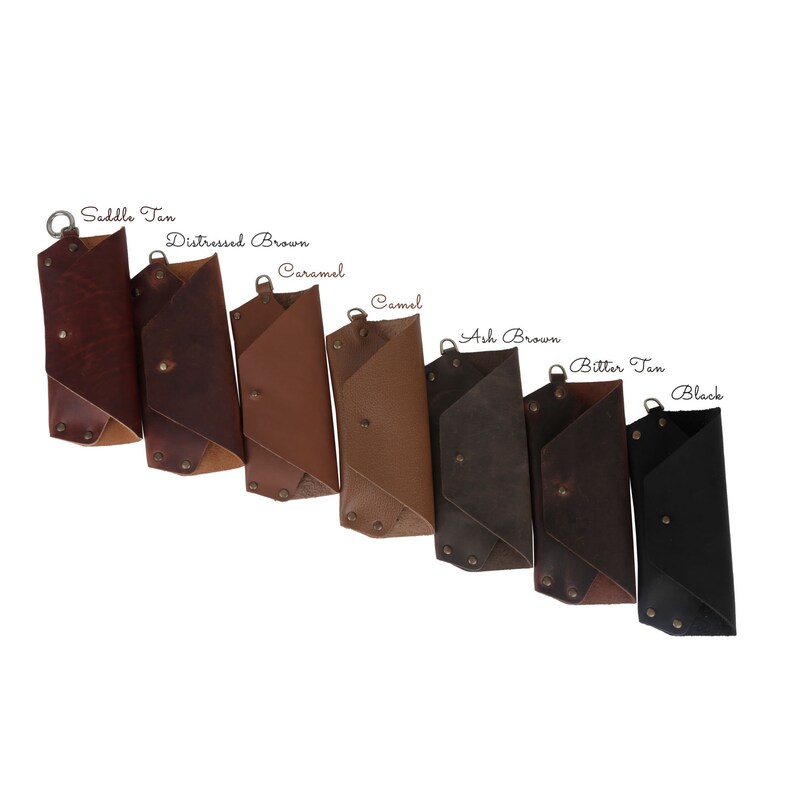 May include: Eight leather wallets in different colors: Saddle Tan, Distressed Brown, Caramel, Camel, Ash Brown, Bitter Tan, and Black.