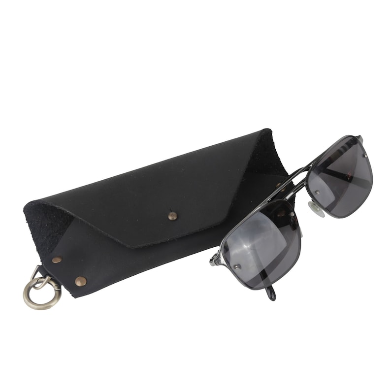 May include: Black leather sunglasses case with a metal clasp and a pair of black sunglasses with silver frames.
