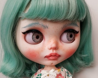 Blythe, pastel blue hair, candy girl. White skin, jointed body