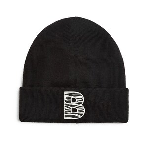 May include: Black knitted beanie with a white and black zebra print letter "B" on the front.