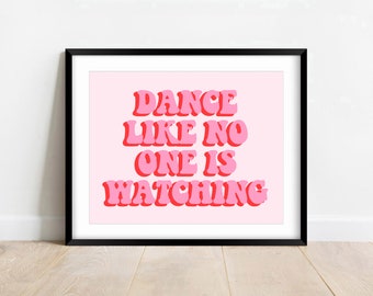 May include: A framed print with a pink background and the text "DANCE LIKE NO ONE IS WATCHING" in a bold, pink font with a red outline.