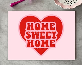 May include: A pink and red heart-shaped graphic with the text "HOME SWEET HOME" in a retro font.