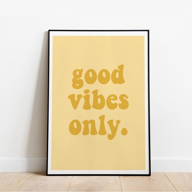 May include: A framed print with a yellow background and the text "good vibes only." in a bold, yellow font.