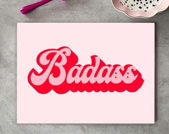 May include: A pink and red print with the word "Badass" in a retro font style.