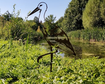 The corten metal swan brightens and enlivens your garden.