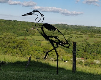 The corten metal heron brightens up and animates your garden.