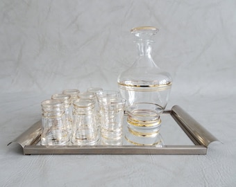 Glass carafe with glasses and mirror tray
