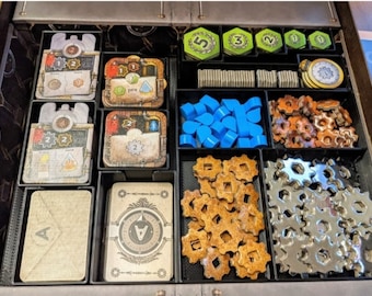 May include: A black organizer tray with compartments for storing game pieces. The tray contains various components, including blue plastic tokens, metal gears, wooden gears, and cards with numbers and symbols.