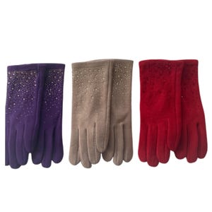 May include: Three pairs of gloves in different colors: purple, tan, and red. Each pair has a row of small, sparkling embellishments along the top edge. The gloves are made of a soft, smooth material.