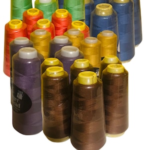 May include: A collection of colorful spools of thread in various shades, including green, red, yellow, blue, purple, and brown. The spools are tightly wound and wrapped in clear plastic, ready for sewing projects.