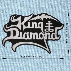 May include: Embroidered black and white patch with the words "King Diamond" and a bat design. The patch is 29.5 cm wide and 19.5 cm tall. Ideal for jackets or bags.