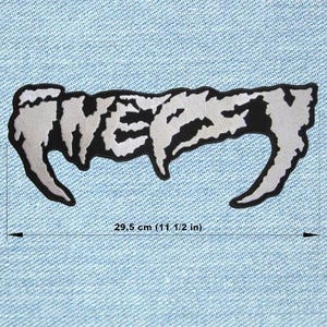 May include: A silver and black patch with the word "FIVER" in a stylized font. The patch is approximately 11 1/2 inches long and is set against a light blue denim background. The patch has a black border.