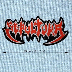 May include: A black and red embroidered patch with the word "SEPULTURA" in a stylized font. The patch measures 11 1/2 inches in length. The text is in red with a silver outline, set against a black background.
