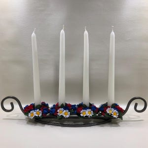 May include: A set of three ceramic mugs with a speckled, matte finish. Each mug features a different color: light blue, cream, and gray. The mugs have a simple, modern design with a rounded shape and a comfortable handle.