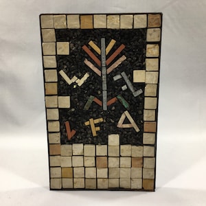 May include: A framed mosaic artwork featuring a stylized tree design with brown, red, and blue tiles on a black background. The frame is made of small white and beige tiles.