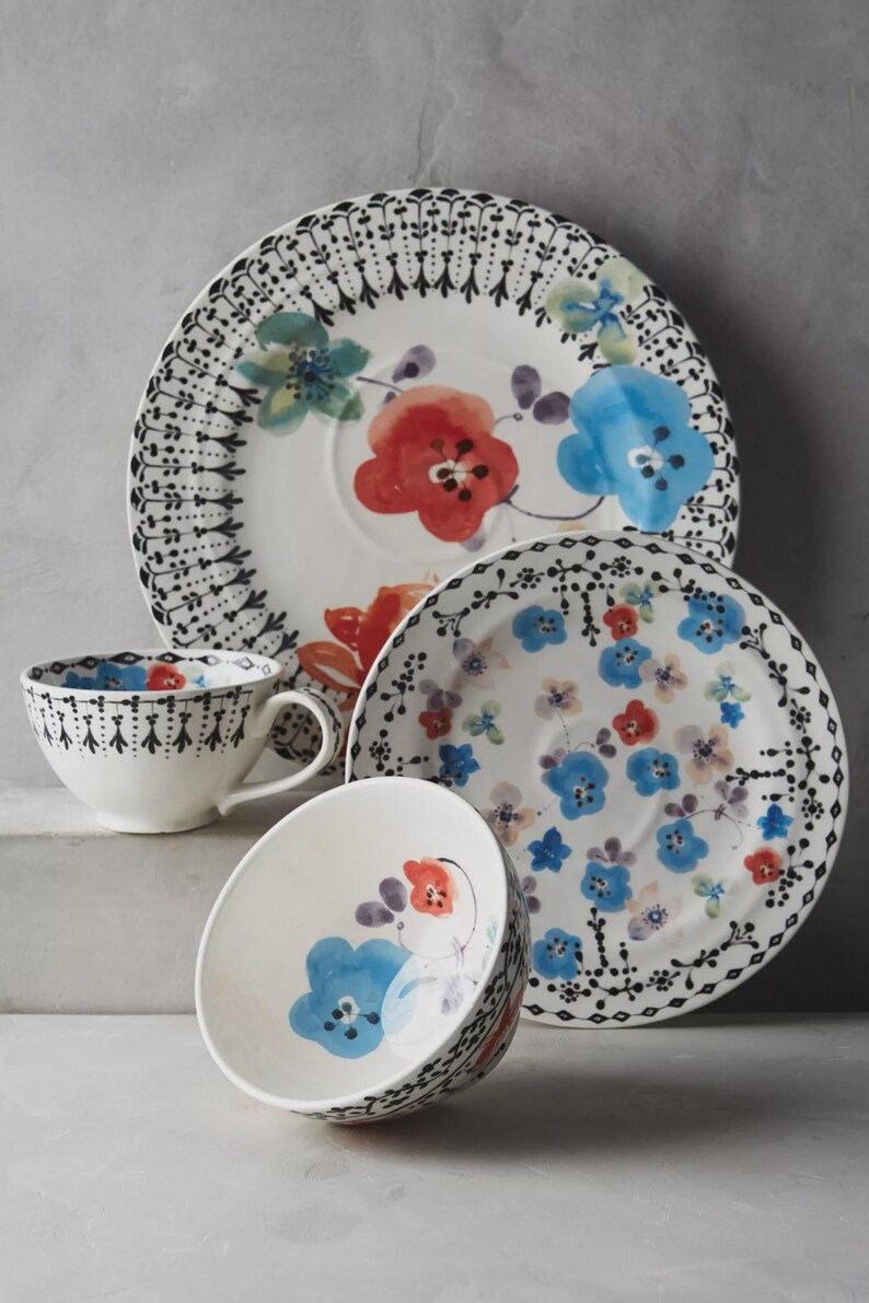 May include: A set of three ceramic nesting bowls in shades of blue, green, and white. The bowls feature a speckled glaze and a simple, modern design. The largest bowl measures approximately 6 inches in diameter.