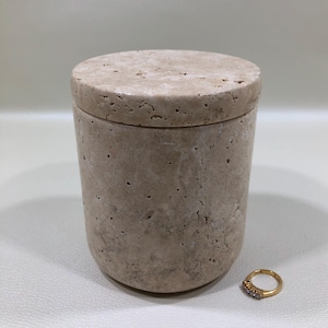 May include: A set of three ceramic mugs with a speckled, matte finish. The mugs are in shades of cream, light brown, and dark brown. Each mug has a simple, minimalist design, perfect for coffee or tea.