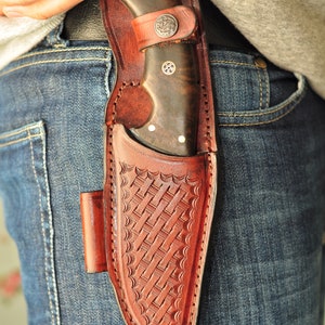 Knife held in hand demonstrating precision grip for tracking and field cuts.