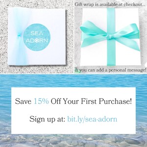 May include: Two white gift boxes, one tied with a light blue ribbon, the other sealed with light blue tulle and a round sticker with the text "SEA ADORN". The image also includes text that says "Save 15% Off Your First Purchase!" and "Sign up at: bit.ly/sea-adorn".