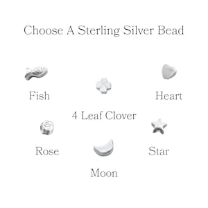 May include: Image featuring a selection of sterling silver beads in various shapes: a fish, a four-leaf clover, a heart, a rose, a moon, and a star. The text "Choose A Sterling Silver Bead" is at the top, with each bead labeled below.