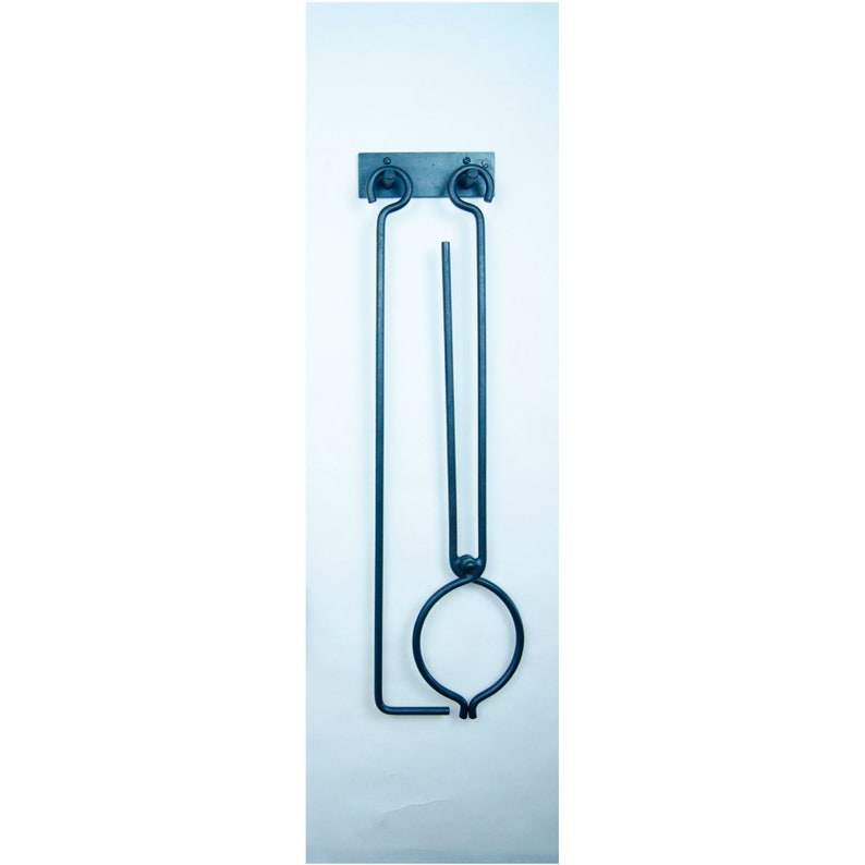 May include: A black metal fireplace tool set with a poker and tongs hanging on a wall mount. The tools are made of wrought iron and have a rustic finish.
