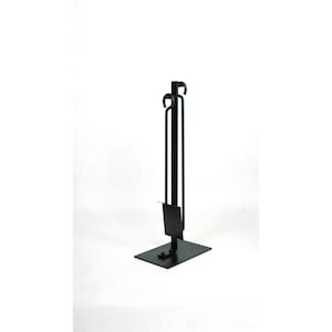 May include: Black metal fireplace tool set with a stand, shovel, poker, and tongs.