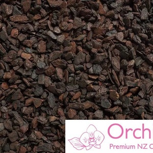 May include: Close-up of dark brown orchid bark, a popular growing medium for orchids. The bark is made of small, irregular pieces. The image includes the text "Orchiata™ Premium NZ Orchid Bark".