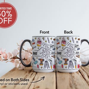 May include: White ceramic mug with a black handle and rim, featuring a design with tools, fists, and the word "DAD". The mug has the names "Olivia", "Alex", and "Chris". The text "Printed on Both Sides" is also visible.