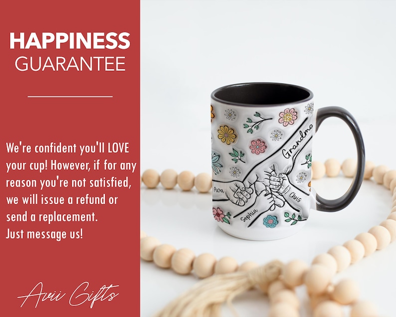 May include: White ceramic mug with a black handle. The mug has a design of hands holding each other with the names "Grandma", "Chris", "Sophia", and "Pasa" written on the hands. The mug is surrounded by small flowers and leaves.