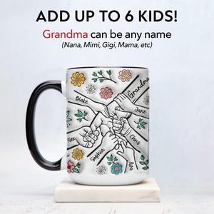 May include: White ceramic mug with a black handle. The mug has a design of six hands holding each other with the names "Grandma", "Blake", "Alex", "Sophia", "Jane", "Chris", and "Ava" written on the hands. The design is surrounded by colorful flowers.