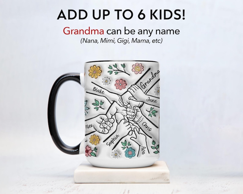 May include: White ceramic mug with a black handle. The mug has a design of six hands holding each other with the names "Grandma", "Blake", "Alex", "Sophia", "Jane", "Chris", and "Ava" written on the hands. The design is surrounded by colorful flowers.