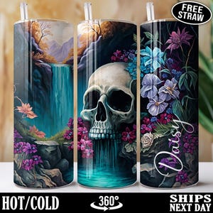 May include: Three stainless steel tumblers with lids and straws. The tumblers feature a wraparound design with a skull, flowers, and a waterfall scene. The text "Daisy" is on one tumbler. The tumblers are designed for hot or cold beverages.