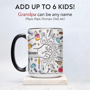 May include: White ceramic mug with a black handle and rim. The mug features the text "Grandpa" with illustrations of tools and fists, surrounded by names. The top text reads "ADD UP TO 6 KIDS!" and "Grandpa can be any name".