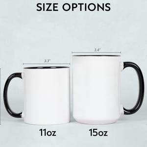 May include: Two white ceramic mugs with black handles and rims are displayed, showcasing size options. The smaller mug is 3.8" high and 3.3" wide, labeled "11oz." The larger mug is 4.7" high and 3.4" wide, labeled "15oz." The text "SIZE OPTIONS" is at the top.