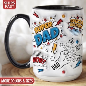 May include: White ceramic mug with a black handle and rim, featuring a "Super Dad" comic book style design. The mug includes the names "Alex", "Olivia", and "Chri". The mug also has the words "Wow!" and "Special Edition".