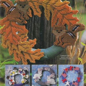 May include: Three different wreaths decorated with various seasonal themes. The top wreath features a squirrel and autumn leaves in shades of orange and brown. The left wreath features snowmen and a blue background. The right wreath features red stars and American flags on a blue background. Celebrate each season with a decorative wreath.