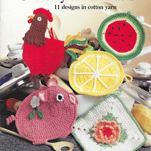 May include: A crochet pattern book titled "Plenty of Potholders" with 11 designs in cotton yarn. The cover features a variety of crocheted potholders, including a rooster, a watermelon, a lemon, a pig, and a flower.