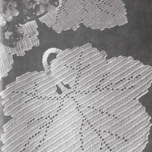 May include: A set of three crocheted doilies in the shape of leaves. The doilies are white and have a delicate lace pattern.
