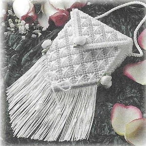 May include: White plastic crocheted purse with a fringe and a diamond pattern. The purse has a flap closure with a white plastic button.