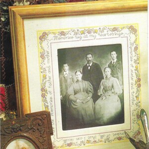 May include: A framed cross-stitch with a floral border and the text "Memories tug at my heartstrings" and "Memories of sister and brother, but the fondest of all, that I can recall are the Memories of father and mother." The frame contains a black and white photo of a family.
