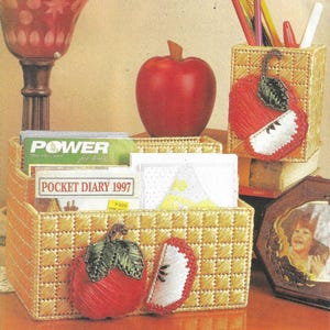 May include: A set of three woven wicker desk organizers shaped like apples. The organizers are decorated with red and white felt apples. The organizers are perfect for holding pens, pencils, and other office supplies.