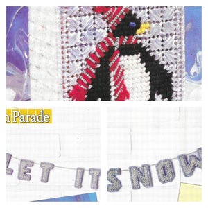 May include: A cross-stitch pattern featuring a penguin wearing a red and white striped scarf and hat. The penguin is set against a white background. Below, a banner reads "LET IT SNOW" in gray letters.