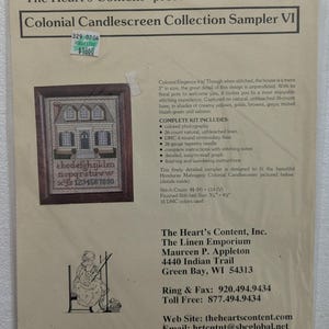May include: A cross-stitch kit titled "Colonial Candlescreen Collection Sampler VI" by "The Heart's Content." The kit includes a framed image of a colonial house with a detailed alphabet and numbers. The kit includes 26-count linen, floss, needle, instructions, and photographs.