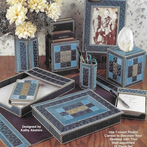May include: A 10-piece desktop organizer set in blue and gold tones. The set includes a picture frame, a tissue box cover, a pencil holder, a letter holder, a notepad holder, and a tray. The set is made of plastic canvas and is designed to be decorated with plastic canvas.