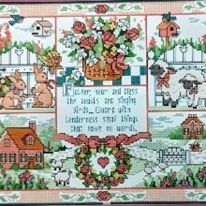 May include: A cross-stitch embroidery featuring a charming country scene with a white picket fence, a red brick house, a basket of flowers, a wreath of roses, and a quote: "Bless the beasts and the birds. Guard with tenderness small things, the have no words."