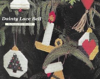 May include: Six colorful Christmas ornaments, including a bell, a candle, a stocking, a heart, a Santa, and a tree. The ornaments are made of plastic canvas and are decorated with beads and sequins. The ornaments are displayed on a green pine branch. The text "Ornamental Treasures" is at the top of the image. The text "Jolly Santa" is below the Santa ornament. The text "Dainty Lace Bell" is below the bell ornament. The text "Patchwork Tree Decor" is below the tree ornament. The text "Adorn your tree with six charming and colorful holiday keepsakes." is in the bottom right corner of the image.