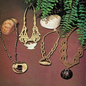 May include: Four necklaces with different shell pendants. The necklaces are made of brown and beige cord and feature a variety of knots and patterns. The pendants are all different shapes and sizes, and some have a natural finish while others are painted.