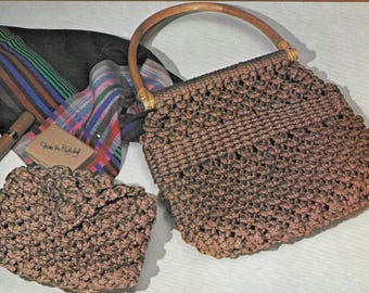 May include: A brown crocheted handbag with a wooden handle. The bag has a woven design and is closed with a flap. There is a smaller brown crocheted purse next to the bag.