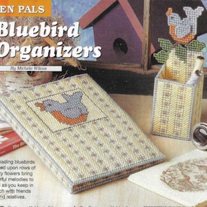 May include: Bluebird themed craft project with a bluebird design on a yellow and white canvas. The project is a pen holder and a notebook cover. The text on the image reads "Pen Pals Bluebird Organizers by Michele Wilcox".