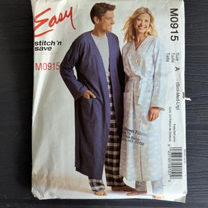 May include: A sewing pattern titled "Easy stitch 'n save" by McCall's, M0915. The pattern cover features a man in a navy blue robe and plaid pants, and a woman in a light blue robe with a floral pattern.